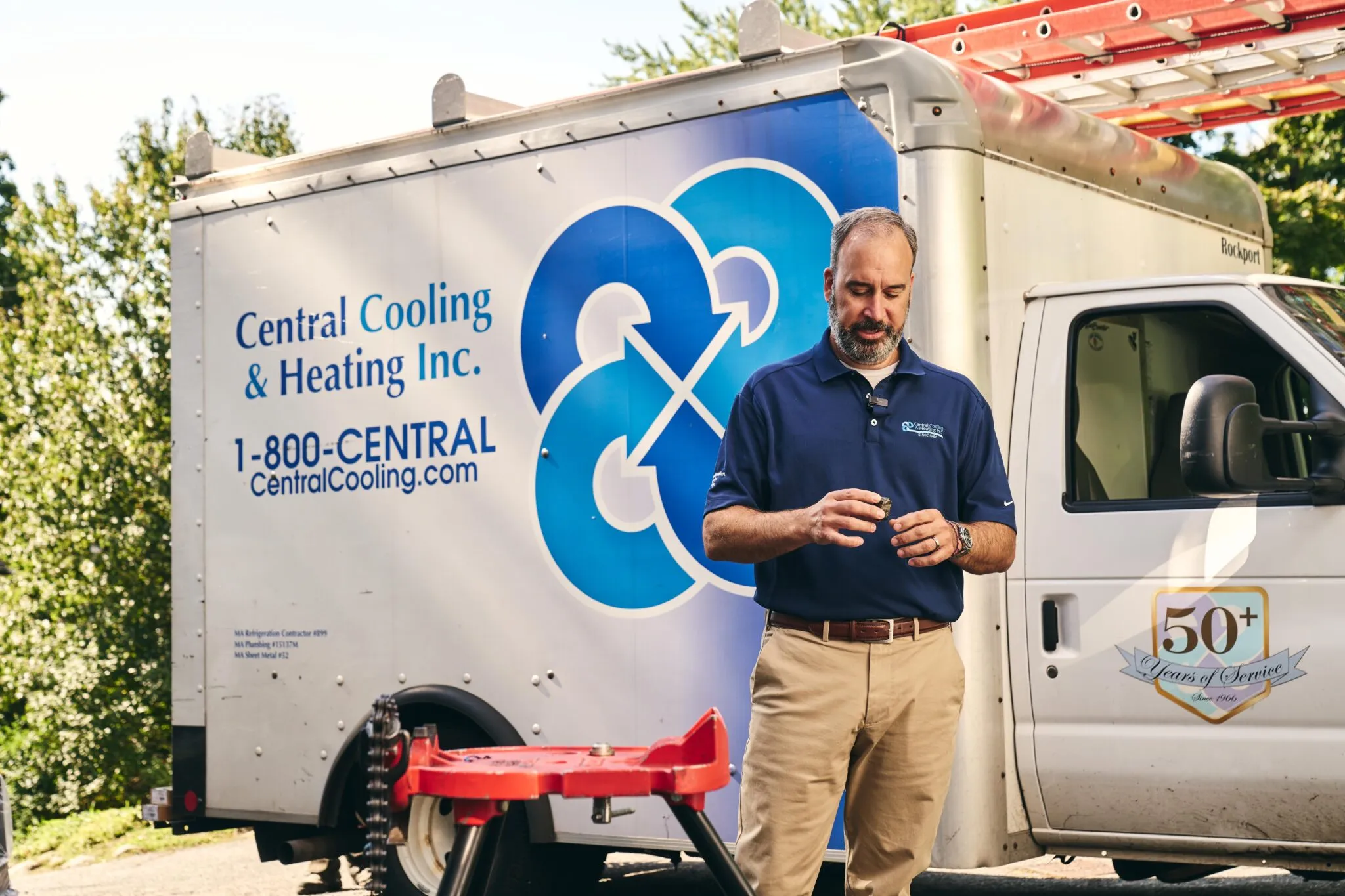 Texas small business owner standing next to company service vehicle